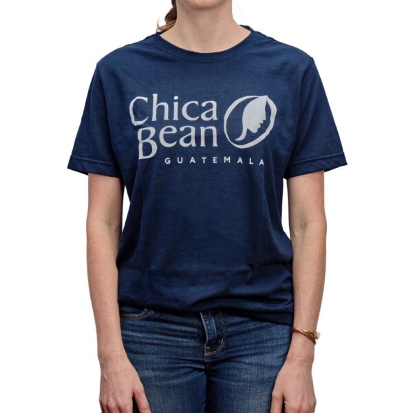 A Navy Blue, unisex crew-neck t-shirt on a female model that has the Chica Bean logo printed in white on the chest.